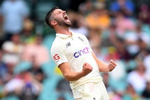 England pacer Mark Wood celebrates after dismissing Marnus Labuschagne of Australia, caught by Jos Buttler, during the first day of the fourth Ashes Test at the Sydney Cricket Cricket on Tuesday