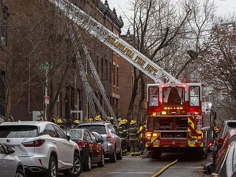 The Philadelphia fire department works at the scene of a deadly row house fire in Philadelphia on Wednesday, Jan. 5, 2022.
