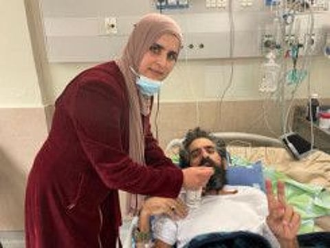 Hisham Abu Hawash is fed by his wife following the end of his hunger strike.