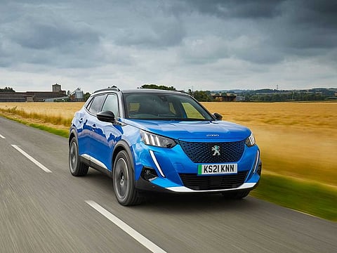 Ads for cars, like the Peugeot e-2008 seen here, will now have to show messages urging viewers or readers to choose sustainable alternatives.