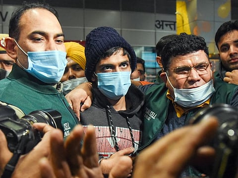 Neeraj Bishnoi, who was brought to the national capital by Delhi Police Special Cell from Assam, at Delhi airport on January 22, 2022.