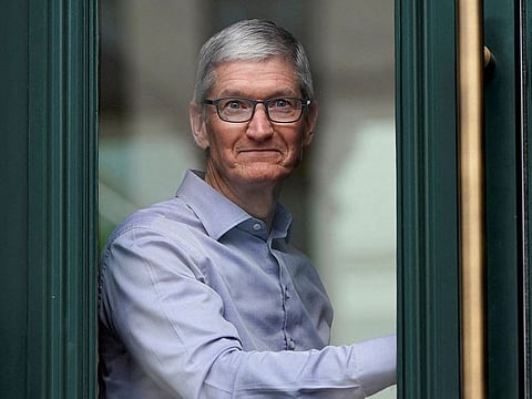 Apple Chief Executive Officer Tim Cook watches customers awaiting the grand opening of the new Apple Carnegie Library store in Washington, U.S., May 11, 2019.