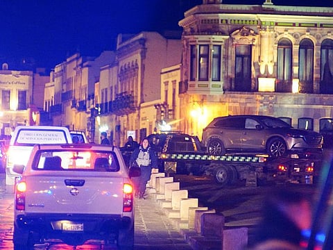 Police forces work at the scene as they remove a vehicle with bodies that were left by unknown assailants in front of the Government Palace, in Zacatecas, Mexico January 6, 2022.