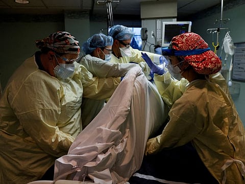 Medical staff treat a coronavirus disease (COVID-19) patient in their isolation room on the Intensive Care Unit (ICU) at Western Reserve Hospital in Cuyahoga Falls, Ohio, U.S., January 4, 2022.