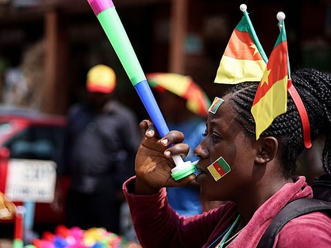A street vendor blows on a vuvuzela at the central market in Yaounde ahead of the African Cup of Nations