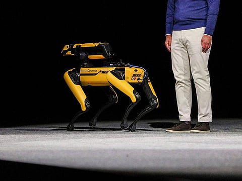 Euisun Chung, chairman of Hyundai Motor Group, takes the stage with Spot from Boston Dynamics during the Hyundai news conference.