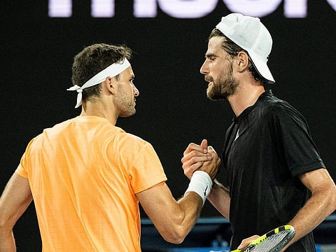 Maxime Cressy is congratulated by Grigor Dimitrov