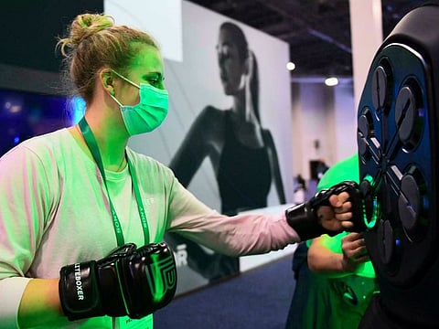 An attendee uses a Liteboxer interactive boxing home workout during the Consumer Electronics Show (CES) on January 7, 2022 in Las Vegas, Nevada.