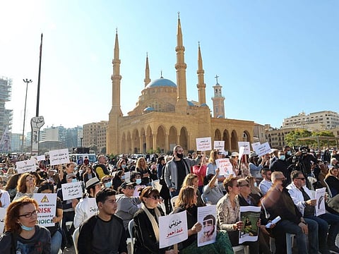 Lebanese protest against the mandatory COVID-19 vaccine pass in the centre of Lebanon's capital Beirut, near the Mosque of Mohammed Al Amin, on January 8, 2022.