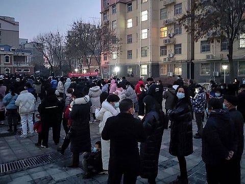 This photo taken on January 8, 2022 shows residents queueing to undergo nucleic acid tests for the COVID-19 coronavirus in Huaxian county, Anyang city, in China's central Henan province.