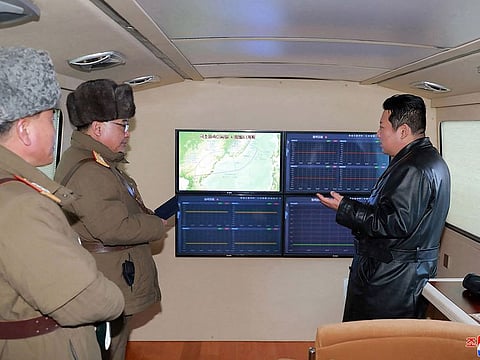 This picture taken on January 11, 2022 and released from North Korea’s official Korean Central News Agency (KCNA) on January 12, 2022 shows North Korean leader Kim Jong Un (R) speaking with military officials during an observation of what state media says a hypersonic missile test-fire conducted by the Academy of Defence Science of the DPRK at an undisclosed location in North Korea.