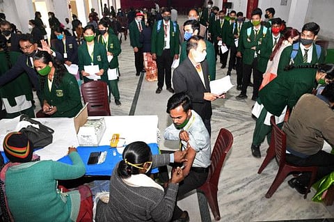 A student gets inoculated with a dose of the COVID-19 vaccine at a school in Patna on January 10.