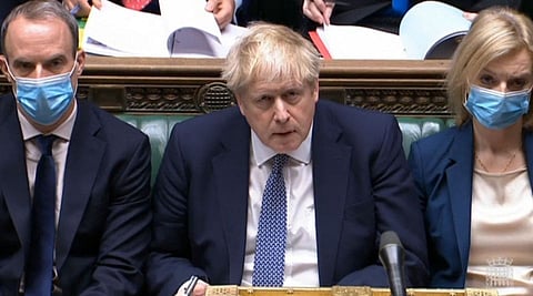 Johnson reacts during Prime Minister's Questions in the House of Commons in London on January 12, 2022.