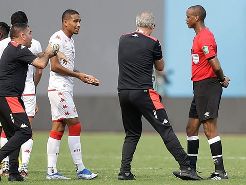 Tunisia’s head coach Mondher Kebaier gestures to the referee Janny Sikazwe of Zambia, claiming that he ended the match early in the African Cup of Nations match between Tunisia and Mali at the Limbe Omnisport Stadium in Limbe, Cameroon, Wednesday, Jan. 12, 2022.