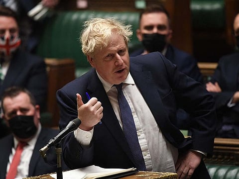A handout photograph released by the UK Parliament shows Britain's Prime Minister Boris Johnson gesturing during the Prime Minister’s COVID-19 Update in the House of Commons in London
