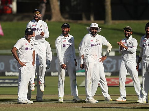 Indian players celebrate the dismissal of South African skipper Dean Elgar towards the end of day's play at Newlands in Cape Town on Thursday.