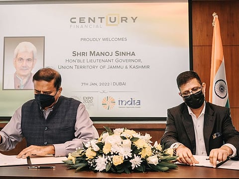 Century Financial’s Bak Krishen signs the deal on the $100 million investment commitment.