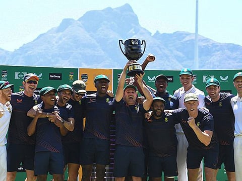 Jubilant members of South Africa team with skipper Dean Elgar holding the series winners' trophy on Friday.