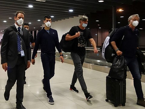 Serbian tennis player Novak Djokovic walks in Melbourne Airport before boarding a flight, after the Federal Court upheld a government decision to cancel his visa to play in the Australian Open, in Melbourne, Australia.