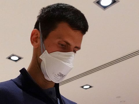 Serbian tennis player Novak Djokovic at the Melbourne airport before boarding a flight, after the Federal Court upheld a government decision to cancel his visa to play in the Australian Open, in Melbourne on January 16, 2022.