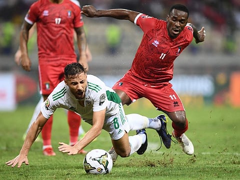Equatorial Guinea's defender Basilio Ndong (right) fights for the ball with Algeria's forward Youcef Belaili (left) during the Group E Africa Cup of Nations (CAN) 2021 football match at Stade de Japoma in Douala.