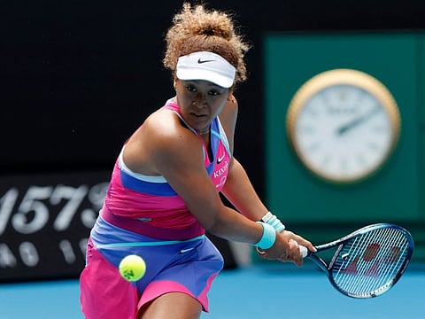 Japan's Naomi Osaka hits a return against Colombia's Camila Osorio during their women's singles match on day one of the Australian Open tennis tournament in Melbourne.