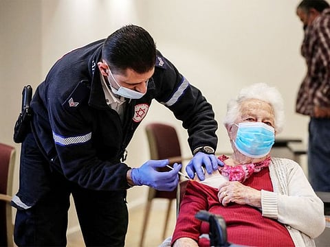 An old woman receives a fourth dose of the COVID-19 vaccine following a vaccination party after Israel approved a second booster shot for the immunocompromised, people over 60 years and medical staff in a retirement home in Netanya, Israel.