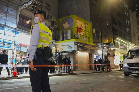 A police officer stands guard outside a pet shop which is closed after some pet hamsters were, authorities said, tested positive for the coronavirus, in Hong Kong, Tuesday.