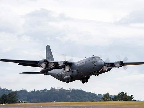 In this photo provided by the New Zealand Defence Force, a Royal New Zealand Air Force C-130 Hercules leaves an airbase in Auckland, Thursday, Jan. 20, 2022, flying to Tonga with aid.