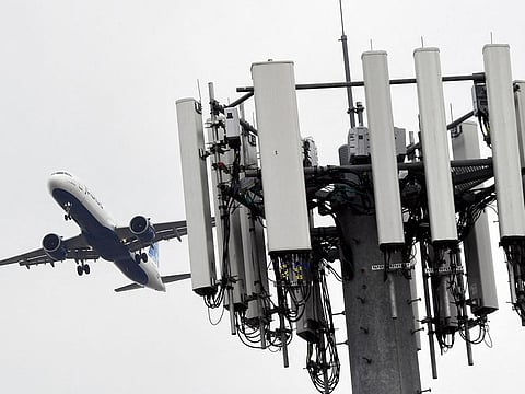 A cellular tower stands as an JetBlue Airbus A321neo airplane lands at Los Angeles International Airport (LAX) in the Lennox neighborhood of Los Angeles, California on January 19, 2022. The limits on 5G deployments and the FAA approvals meant little interruption at larger airports across the US.