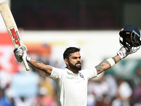 Indian cricket captain Virat Kohli celebrates after scoring a century on the third day of the second Test against Sri Lanka at the Vidarbha Cricket Association Stadium in Nagpur, on November 26, 2017.
