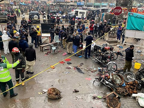 Police officials examine the site of bomb explosion, in Lahore, Pakistan on January 20.