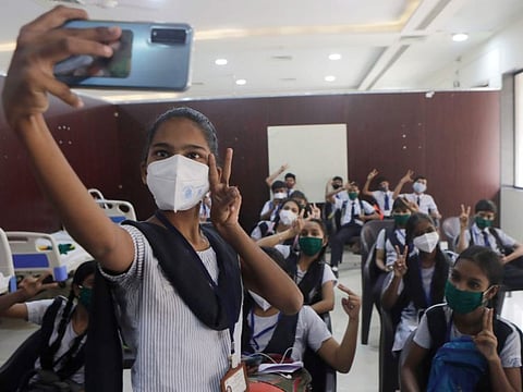 An Indian school girl take selfie after receiving vaccination for COVID-19 in Mumbai, on January 7, 2022.