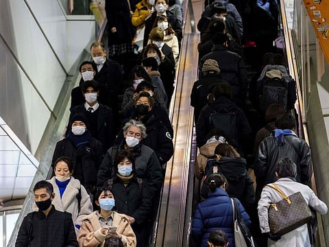 Japanese in Tokyo's Shibuya district on January 19, 2022, as government approved new restrictions on a large part of the country, including the capital to battle record infections fuelled by the Omicron variant.