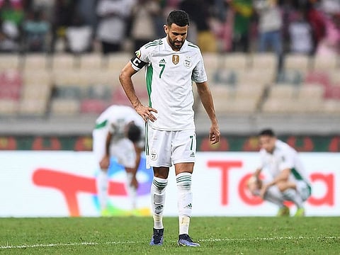Algeria’s Riyad Mahrez reacts after Ivory Coast forward Nicolas Pepe (not seen) scores his side’s third goal in the Africa Cup of Nations group game at Stade de Japoma in Douala on January 20, 2022.