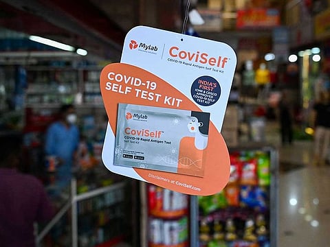 In this picture taken on January 18, 2022, an advertisement of the CoviSelf Rapid Antigen Test (RAT) kit to self-test for the Covid-19 coronavirus is seen at a chemist shop in Lonavla, some 90 km south-east of Mumbai.