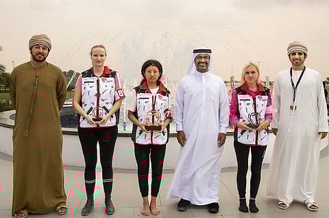 The top three winners in the camel race, with officials.