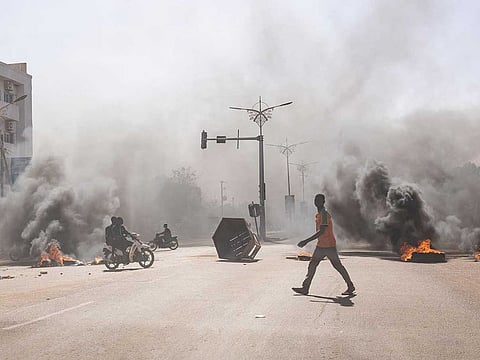 Burkina Faso: A man crosses through burning barricades in the central avenues in Ouagadougou during the unrest earlier this year