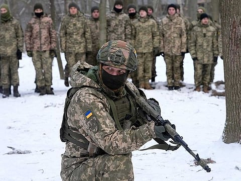 An instructor trains members of Ukraine's Territorial Defence Forces, volunteer military units of the Armed Forces, in a city park in Kyiv, Ukraine, Saturday, Jan. 22, 2022