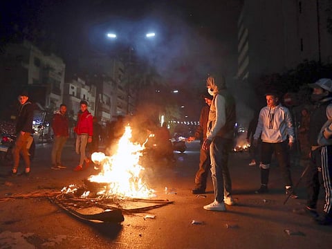 Supporters of former Lebanese Prime Minister Saad Hariri burn tires to block a main road in Beirut, Lebanon on January 24, 2022. Hariri said Monday he is suspending his work in politics and will not run in May's parliamentary elections.