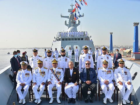 Pakistan's President Dr Arif Alvi with Pakistan Navy officials onboard PNS Tughril during the induction ceremony in Karachi on January 24, 2022.
