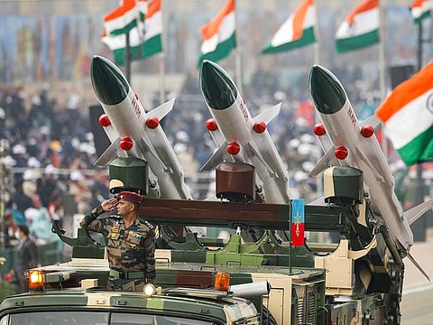 An Indian soldier salutes while standing in a vehicle during the Republic Day parade in New Delhi, on January 26, 2022.