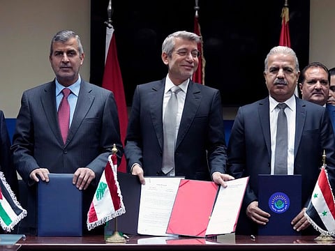 Lebanon’s Energy Minister Walid Fayyad, center, Jordanian Energy Minister Saleh Kharabsheh, left, and Syria’s Electricity Minister Ghassan Al Zamil, pose for a photograph after they sign deals to bring electricity from Jordan through Syria to Lebanon, at the Ministry of Energy and Water in Beirut on January 26.
