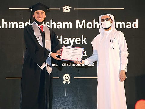 Salah Bukhatir, Chairman, BEAM, presents a certificate to a graduate