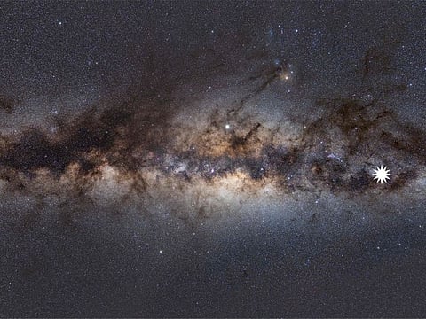 This undated handout image provided on January 26, 2022 by astrophysicist Natasha Hurley-Walker from the Curtin University node of the International Centre for Radio Astronomy Research (ICRAR) shows the Milky Way as viewed from Earth, with a star icon (at right-placed by source) marking the position of a mysterious repeating transient in space. - Australian researchers have discovered a strange spinning object in the Milky Way they say is unlike anything astronomers have ever seen.