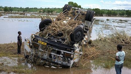 Locals look at a wreck washed away during Tropical Storm Ana on the flooded Shire river, an outlet of Lake Malawi at the village of Thabwa in Chikwawa district, southern Malawi, January 26, 2022.