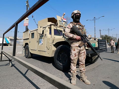 Iraqi soldiers man a checkpoint in the the capital Baghdad on January, 28,2022, following a rocket attack on the country's airport.