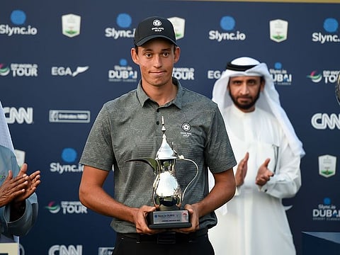 Dubai-based golfer Josh Hill receiving his award for top amateur at the Slync.io Dubai Desert Classic at Emirates Golf Club