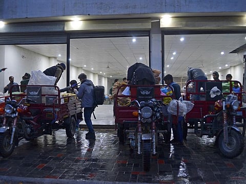 In this picture taken on January 8, 2022, workers of Taza Transforming Agriculture load vegetable bags on rickshaws at a distributing point in Lahore. Agriculture entrepreneurs are bringing the digital age to Pakistan's farmers, helping them plan crops better - and also distribute their produce when the time is right.