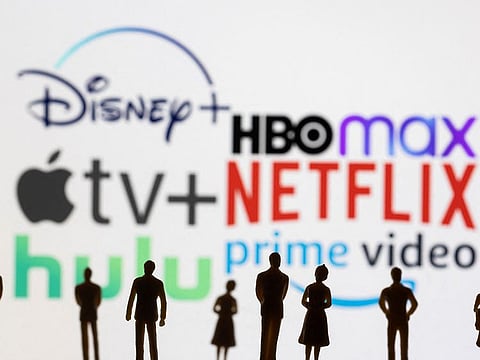 Toy figures of people are seen in front of the displayed Disney+, HBO Max, Apple TV, Netflix, Hulu and Prime video logos, in this illustration taken January 20, 2022.